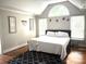 This bedroom offers 3 windows, an area rug and hardwood floors at 520 Beacon Knoll Ln, Fort Mill, SC 29708