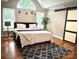 Bright bedroom featuring a sliding barn door, a neutral color palette, and a large arched window at 520 Beacon Knoll Ln, Fort Mill, SC 29708