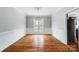 Dining room boasting hardwood floors, decorative light fixture, and traditional wainscoting, perfect for entertaining at 520 Beacon Knoll Ln, Fort Mill, SC 29708