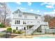 Back of home with stairs to a second story deck, backyard with a pool, lush green lawn and trees at 520 Beacon Knoll Ln, Fort Mill, SC 29708