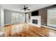 Spacious living room features hardwood floors, a cozy fireplace, and several windows offering natural light at 520 Beacon Knoll Ln, Fort Mill, SC 29708
