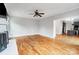 Open-concept living room with hardwood floors, fireplace, and a seamless flow into the kitchen at 520 Beacon Knoll Ln, Fort Mill, SC 29708