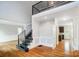 View of the home's entryway with hardwood floors, modern banister, and large opening to an adjacent room at 520 Beacon Knoll Ln, Fort Mill, SC 29708