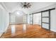Spacious main bedroom with hardwood floors, ceiling fan, and custom barn door to the walk-in closet at 520 Beacon Knoll Ln, Fort Mill, SC 29708