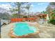 Inviting backyard pool with stone accents, an outdoor kitchen, and a spa under a pergola at 520 Beacon Knoll Ln, Fort Mill, SC 29708