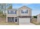 Charming two-story home featuring stone accents and a welcoming two-car garage at 5540 Pamplona Way, Charlotte, NC 28214