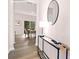 Welcoming hallway with wood flooring, a console table, and an elegant round mirror at 5540 Pamplona Way, Charlotte, NC 28214