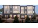 Modern townhome showcases a gray and white facade with multiple windows, offering ample natural light at 6013 Pivot Ct, Charlotte, NC 28205