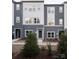 Exterior view of modern townhomes featuring coordinated color schemes and minimalist landscaping at 6013 Pivot Ct, Charlotte, NC 28205