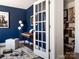 Cozy home office with dark blue walls, piano, stylish lamp, decorative rug, and bright white trim at 6013 Pivot Ct, Charlotte, NC 28205