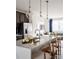 Bright kitchen with marble countertop island, bar stool seating, and modern pendant lighting at 6013 Pivot Ct, Charlotte, NC 28205