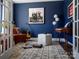 Inviting home office with dark blue accent wall, decorated with music-inspired decor at 6013 Pivot Ct, Charlotte, NC 28205
