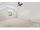 Finished attic space with dormer window and ceiling fan at 8309 Shinkansen Dr, Charlotte, NC 28213
