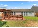 Spacious backyard deck and covered patio area, perfect for entertaining guests, located at rear of home at 8309 Shinkansen Dr, Charlotte, NC 28213