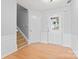 Bright entryway with staircase, white trim, and light hardwood floors at 8309 Shinkansen Dr, Charlotte, NC 28213