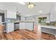 Open concept view of kitchen and living spaces, bright natural lighting, breakfast bar at 8309 Shinkansen Dr, Charlotte, NC 28213