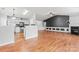Open living space joining the kitchen and living room, featuring hardwood floors and natural light at 8309 Shinkansen Dr, Charlotte, NC 28213