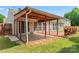 Backyard of home with a covered patio, open deck, and sliding doors to the home's interior at 8309 Shinkansen Dr, Charlotte, NC 28213