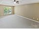 Spacious bedroom with plush gray carpeting, a trey ceiling and large windows offering ample light at 903 Furman Ct, Fort Mill, SC 29708
