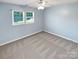 Cozy bedroom with carpet, light blue walls, a ceiling fan, and a window providing natural light at 903 Furman Ct, Fort Mill, SC 29708