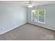 Well lit bedroom with plush carpeting and large window offers a cozy and airy space at 903 Furman Ct, Fort Mill, SC 29708