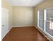Bright bedroom featuring hardwood flooring, white trim, a large window, and neutral paint at 903 Furman Ct, Fort Mill, SC 29708