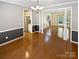 Dining room with hardwood floors and open access to an updated kitchen and sun-lit seating area at 903 Furman Ct, Fort Mill, SC 29708