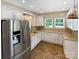Bright kitchen with white cabinets, granite countertops, stainless steel appliances, and tile backsplash at 903 Furman Ct, Fort Mill, SC 29708