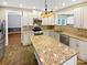 Updated kitchen with granite countertops, stainless steel appliances, island, and custom backsplash at 903 Furman Ct, Fort Mill, SC 29708