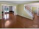 Open living space with hardwood floors, decorative columns, staircase, and access to a sun-lit seating area at 903 Furman Ct, Fort Mill, SC 29708