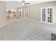 A bright living room has french doors and flows into an updated kitchen with stainless steel appliances at 903 Furman Ct, Fort Mill, SC 29708