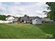 Spacious backyard featuring a well-maintained lawn, deck, and seating area, perfect for outdoor gatherings at 9051 Country Barn Ct, Charlotte, NC 28273