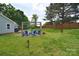 Large backyard with a fire pit and deck offering ample space for outdoor activities and relaxation at 9051 Country Barn Ct, Charlotte, NC 28273
