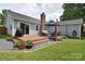 Spacious backyard featuring a wooden deck, well-maintained lawn, and mature trees, perfect for outdoor gatherings at 9051 Country Barn Ct, Charlotte, NC 28273