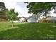 Expansive backyard featuring a well-manicured lawn, a fire pit, and a wooden deck for outdoor enjoyment at 9051 Country Barn Ct, Charlotte, NC 28273