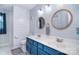Stylish bathroom with double sinks, round mirrors, and shiplap walls at 9051 Country Barn Ct, Charlotte, NC 28273