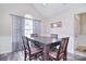 Dining room featuring wainscotting, a modern table and chairs, and large windows at 9051 Country Barn Ct, Charlotte, NC 28273