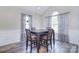 Cozy dining room featuring wainscotting, a modern table and chairs, and large windows at 9051 Country Barn Ct, Charlotte, NC 28273