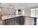 Bright kitchen showcasing an island with seating, stainless appliances, and an open concept layout to the living room at 9051 Country Barn Ct, Charlotte, NC 28273