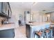 Open kitchen with an island, stainless steel appliances, and a view into the dining and living areas at 9051 Country Barn Ct, Charlotte, NC 28273