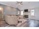 Inviting living room with vaulted ceilings, a fireplace, wood floors, and comfortable seating at 9051 Country Barn Ct, Charlotte, NC 28273
