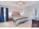 Comfortable main bedroom featuring a ceiling fan, window, and private doorway at 9051 Country Barn Ct, Charlotte, NC 28273