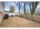 Spacious backyard featuring a grill, patio set, and a secure fence, perfect for outdoor gatherings and relaxation at 92 Saint Charles Ne Ave, Concord, NC 28025