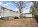 Wide backyard view showcases a fence, storage shed, patio set, deck, and grill, ideal for outdoor enjoyment at 92 Saint Charles Ne Ave, Concord, NC 28025