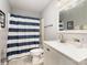 Bathroom featuring a vanity with a bright white countertop and a shower with a blue striped curtain at 92 Saint Charles Ne Ave, Concord, NC 28025