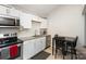 Efficient kitchen features white cabinets, granite countertops, and stainless steel appliances at 92 Saint Charles Ne Ave, Concord, NC 28025