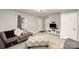 Bright living room features modern gray sofas, a patterned ottoman, and a wall-mounted television at 92 Saint Charles Ne Ave, Concord, NC 28025