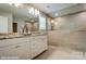Bright bathroom featuring double vanity, granite counters, large mirror, and walk-in shower with neutral tile at 9945 Cask Way, Huntersville, NC 28078