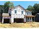 New two-story home featuring an attached two-car garage, covered porch, and large windows at 9945 Cask Way, Huntersville, NC 28078