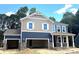 Charming two-story home featuring a two-car garage, stone accents, and a covered front porch at 9945 Cask Way, Huntersville, NC 28078
